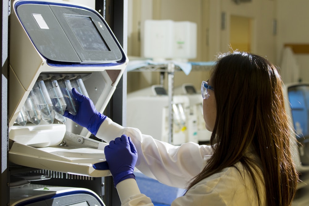 Laboratory technician loading patient samples into a diagnostic analyser